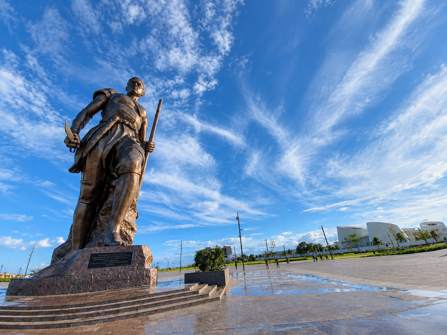 Statue of the Dahomey Amazon in Cotonou, Benin, at dusk